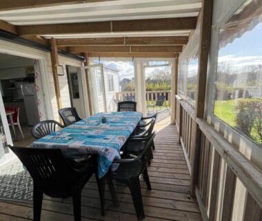 Terrasse couverte avec table et chaises dans le Mobil home confort XL du camping HOMAIR la pommeraie