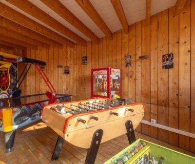 Salle de jeux avec baby-foot et bornes d'arcade dans le mobil-home de Laura et Angélique au camping Le Neptune