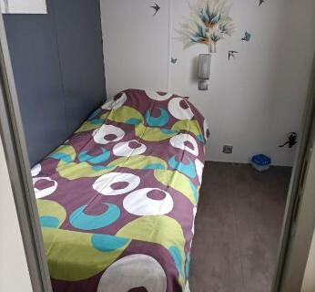Chambre avec lit simple et étagère dans le Mobil-home emplacement 1