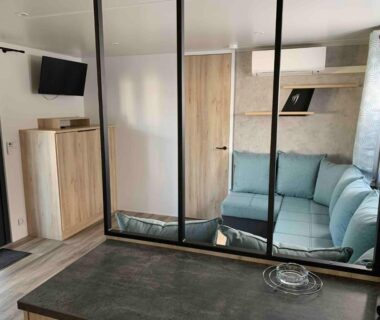 Séjour avec canapé d'angle et télévision dans le mobil home familial N 211