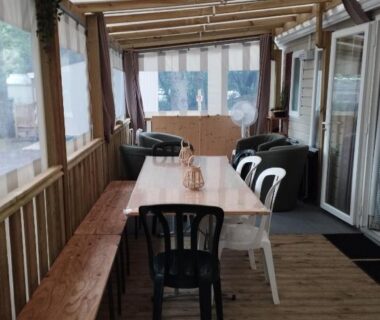 Véranda couverte avec grande table banquette et chaises du Mobil-home tout confort à 300m de l'océan