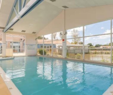 Piscine couverte intérieure avec grandes baies vitrées au Mobil home tout confort dans parc résidentiel de loisirs