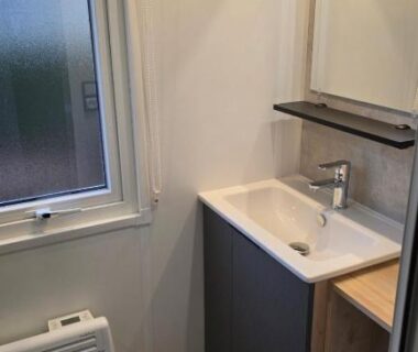 Salle d'eau avec lavabo et miroir dans le Mobile home 4 a 6 personnes Domaine de Kerlann