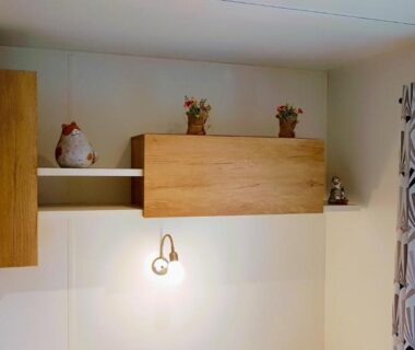 Intérieur avec meuble mural en bois lampe et rideau dans le Mobile home De Luxe St Cyprien