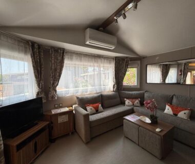 Salon avec canapé et télévision dans le mobil-home Myosotis