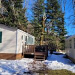 Extérieur enneigé avec mobil-homes et terrasse du Mobile-home confort 3 chambres au camping La Bourboule