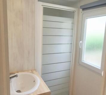 Salle de bain avec douche et lavabo dans le mobilhome