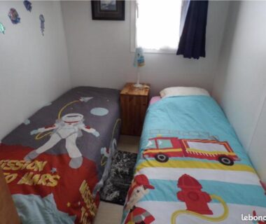 Chambre avec deux lits enfants et lampe dans le Mobilhome