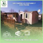 Terrasse et mobilhome sur pelouse au camping Les Fontaines Mobilhome 6P 3CH Nature et Sport