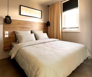 Chambre avec lit double et tête de lit bois dans le Mobilhome Cosy bord de mer