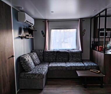 Salon avec canapé d'angle et table basse dans le Mobilhome Côte Landaise Les Dunes de Contis 4
