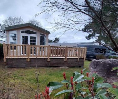 Terrain boisé avec terrasse en bois et mobilhome au Mobilhome Kedidrouz du Léon Kerlann Pont Aven