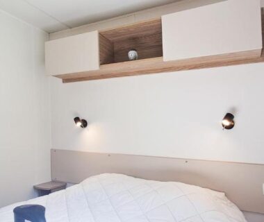 Chambre intérieure avec lit étagère et appliques dans l'hébergement Le Refuge des Pins