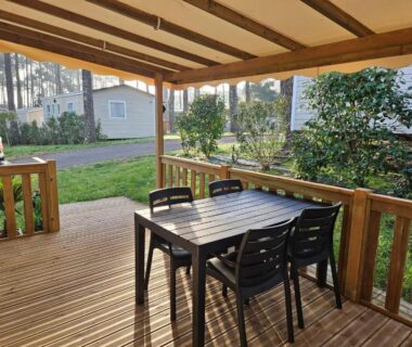 Terrasse couverte avec table et chaises au camping O’ContisParadise