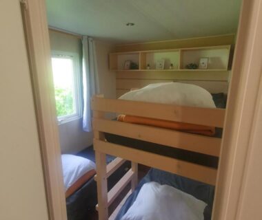 Chambre avec lits superposés et fenêtre dans le mobilhome Paris Eure gestion Mobilhome 2 chambres 5 personnes au calme