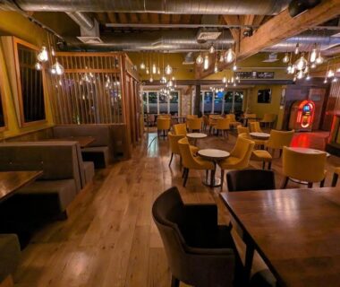 Salle de restaurant intérieure avec tables en bois et éclairage chaleureux du Premium Mobilhome Grimaud