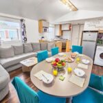 Coin repas avec table dressée et canapé dans le séjour du Séjour convivial en pleine nature