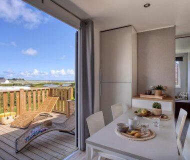 Terrasse avec chaise longue et coin repas donnant sur la mer du Slow Village Breizh Légendes