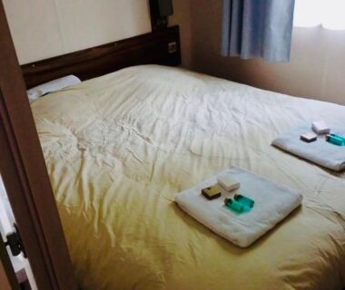 Chambre avec lit double et serviettes dans le Superbe Mobilehome 3 ch climatisé tout confort