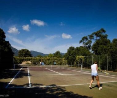 Terrain de tennis entouré d'arbres à la Tente Lodge pour 8 avec Terrasse à Sartène