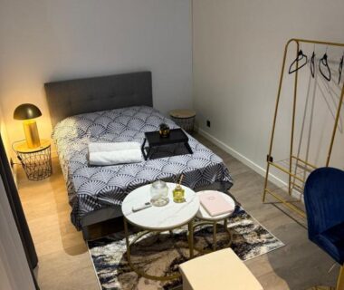 Chambre avec lit double et coin salon dans la Tiny house – piscine et vélos