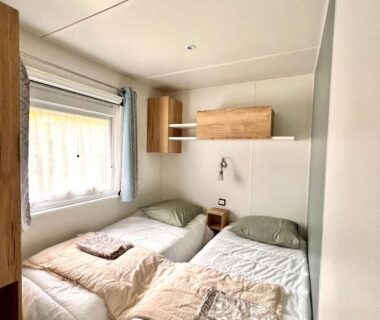 Chambre avec deux lits simples dans le bungalow Un toit sur le bassin