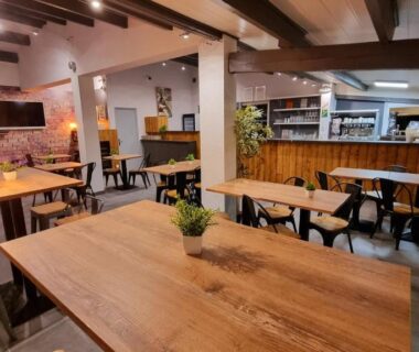 Espace repas intérieur avec tables et bar au Village de Chalets