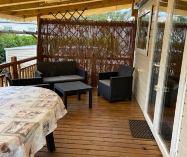 Terrasse couverte avec salon extérieur du camping Vos meilleures vacances au Montourey