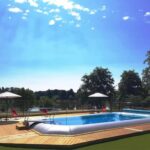 Piscine extérieure sur terrasse en bois au ZEcamping 3 étoiles dog friendly bien-être piscine au bord dun lac
