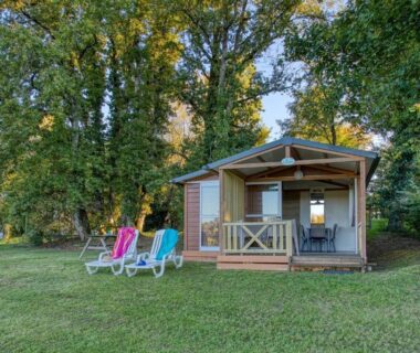 Chalet en bois sur pelouse avec transats au ZEcamping 3 étoiles familial dog friendly
