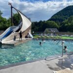 Piscine extérieure avec toboggan en forme de voile au ZEcamping 4 étoiles animaux acceptés tennis piscine couverte