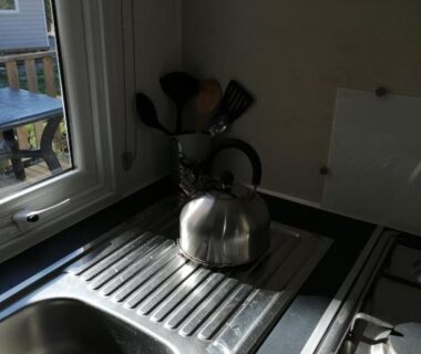 Kitchenette avec bouilloire et évier dans le bungalow au soleil camping les dunes