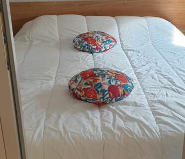 Chambre intérieure avec lit et coussins au camping les sables du midi