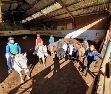 Manège couvert avec cavaliers et chevaux au camping la Frégière Chalets