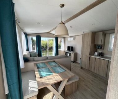 Séjour lumineux avec cuisine et coin repas dans le mobil home climatisé